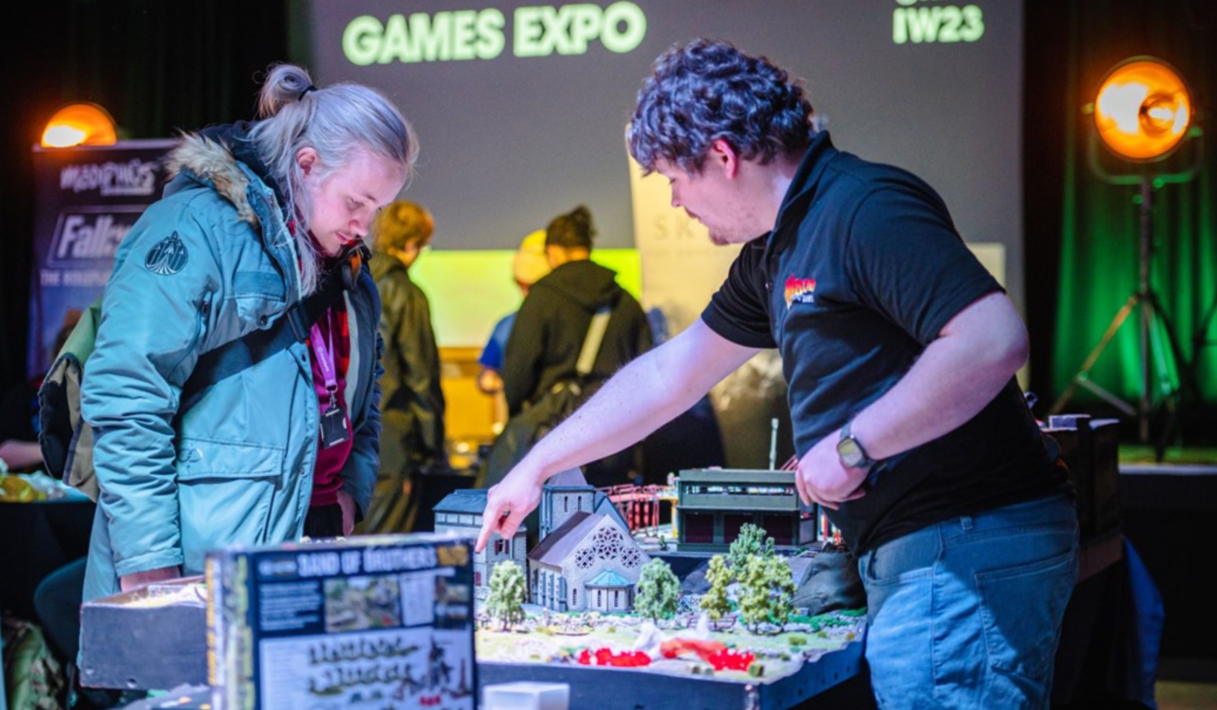 Two people looking at a tabletop game